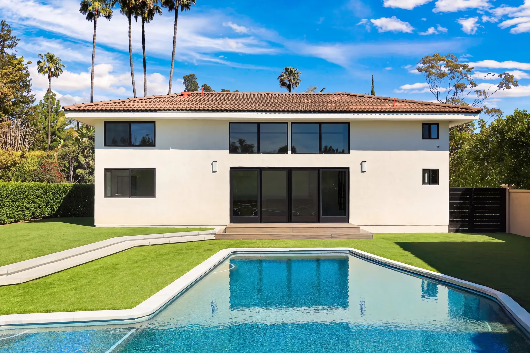 Completed two-story ADU by Avorino in Santa Ana, seen across the backyard pool