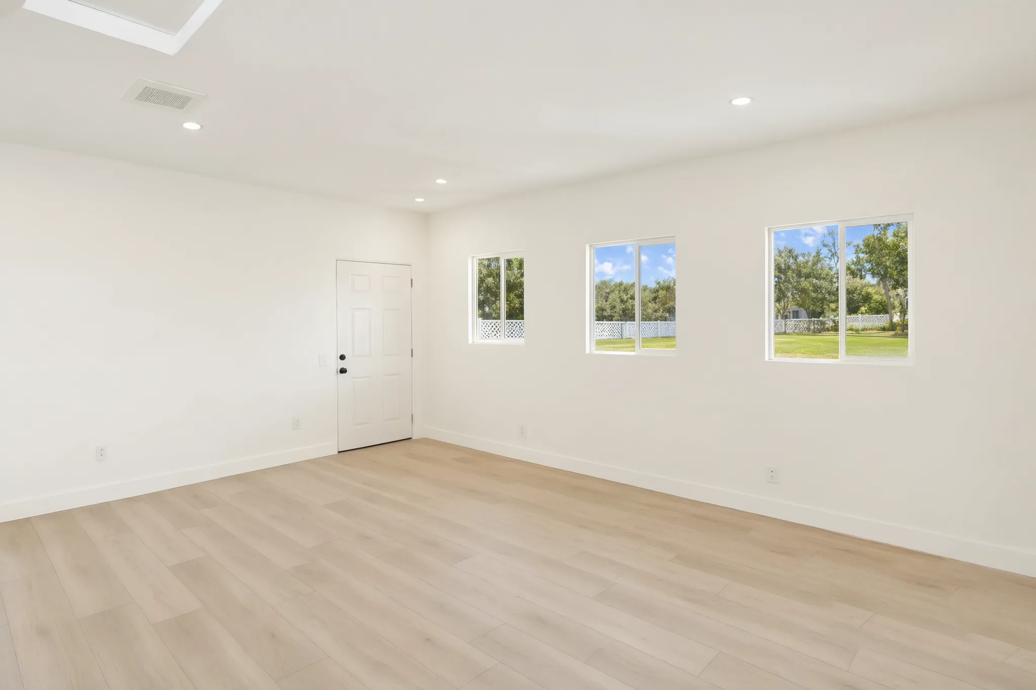 Garage conversion ADU — studio room with three windows, Brea, Avorino