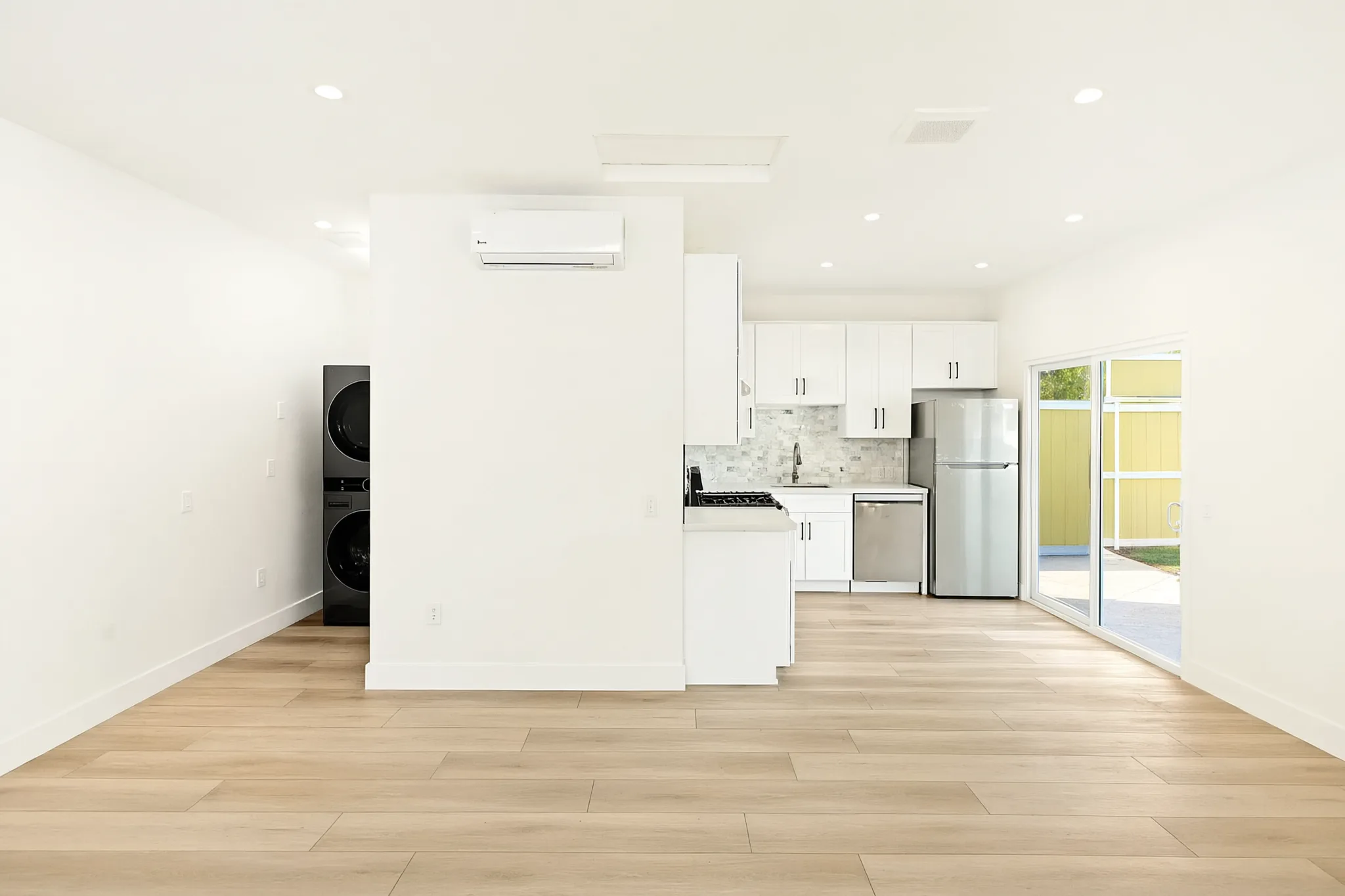 Garage conversion ADU — kitchen and laundry from the living area, Brea, Avorino