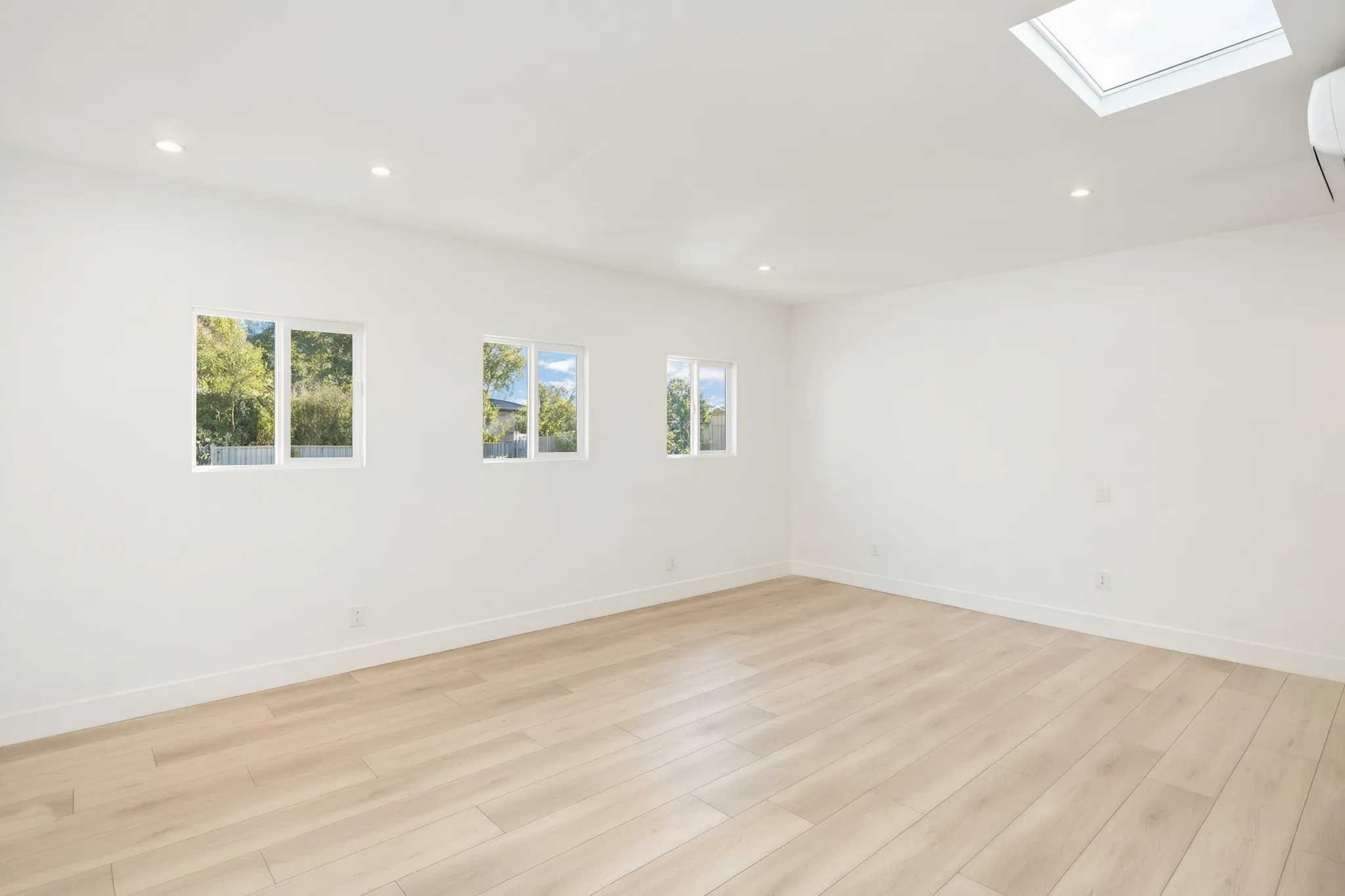 Garage conversion ADU — main room with three windows, Brea, Avorino