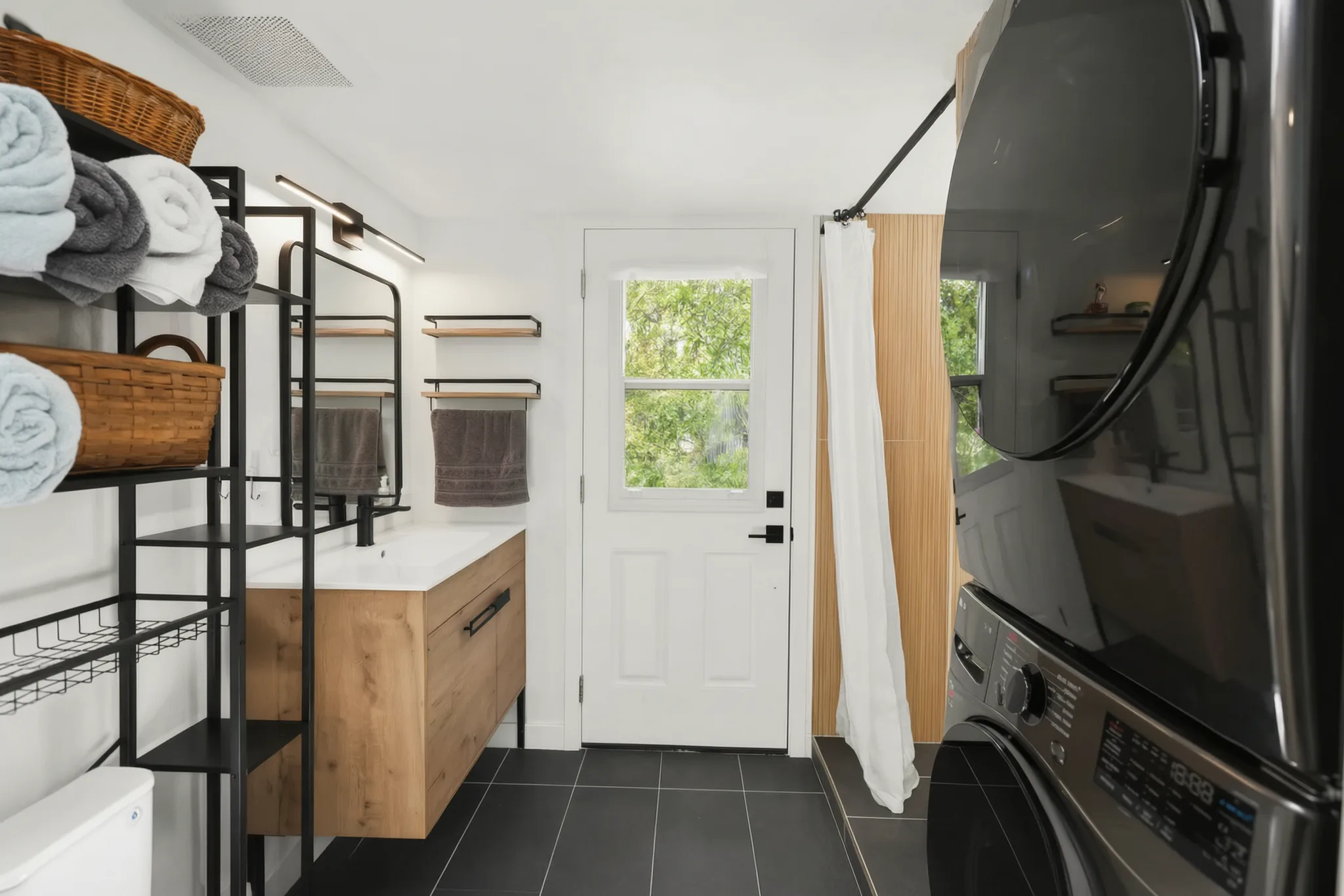Two-story detached ADU — bath with floating vanity and stacked laundry, Santa Ana Hills, Avorino