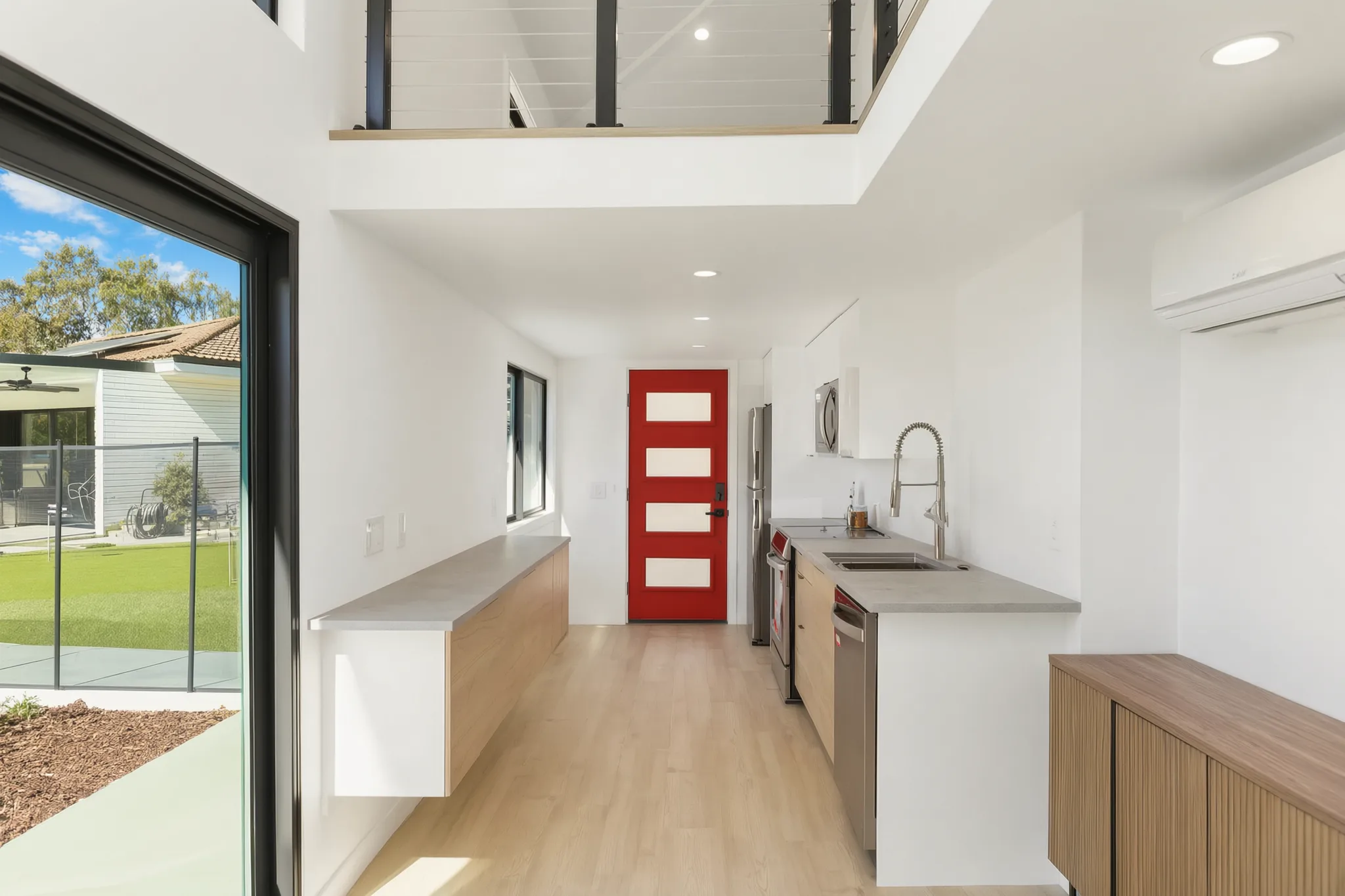 Two-story detached ADU — kitchen run to the red entry door, loft above, Santa Ana Hills, Avorino