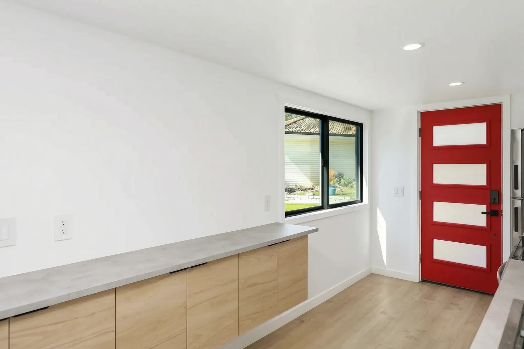 Two-story detached ADU — kitchen counter and red entry door, Santa Ana Hills, Avorino