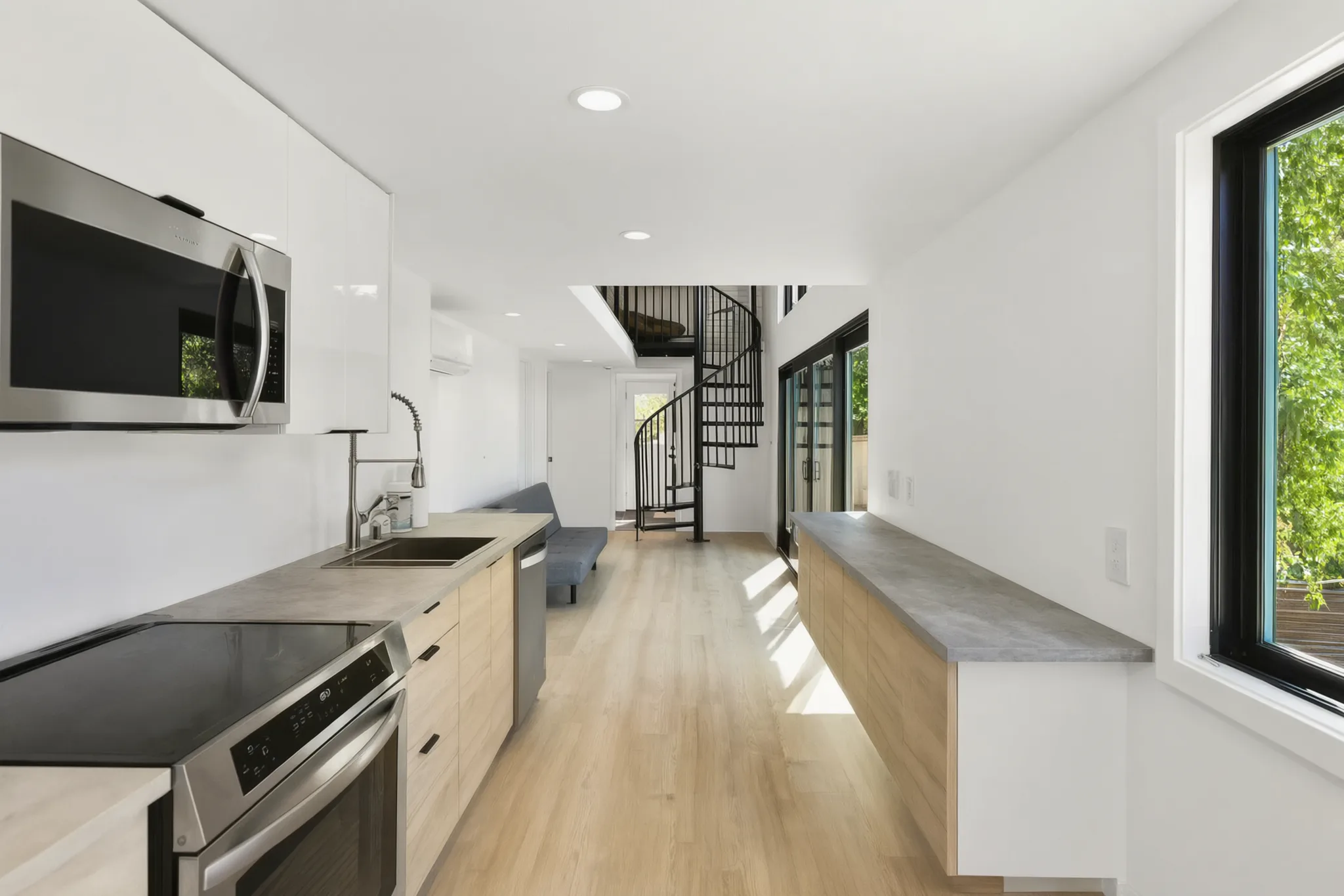 Two-story detached ADU — galley kitchen toward the spiral stair, Santa Ana Hills, Avorino