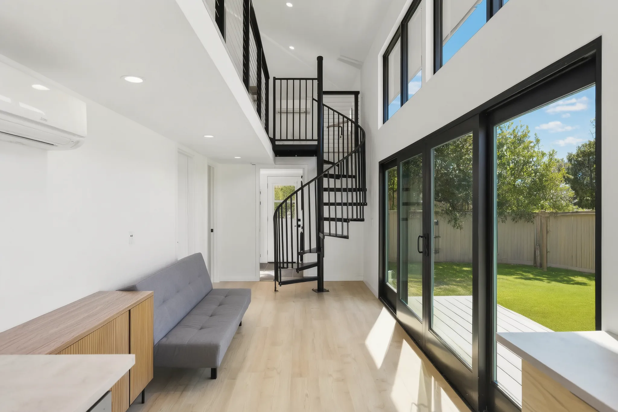 Two-story detached ADU — living room with spiral stair to the loft, Santa Ana Hills, Avorino