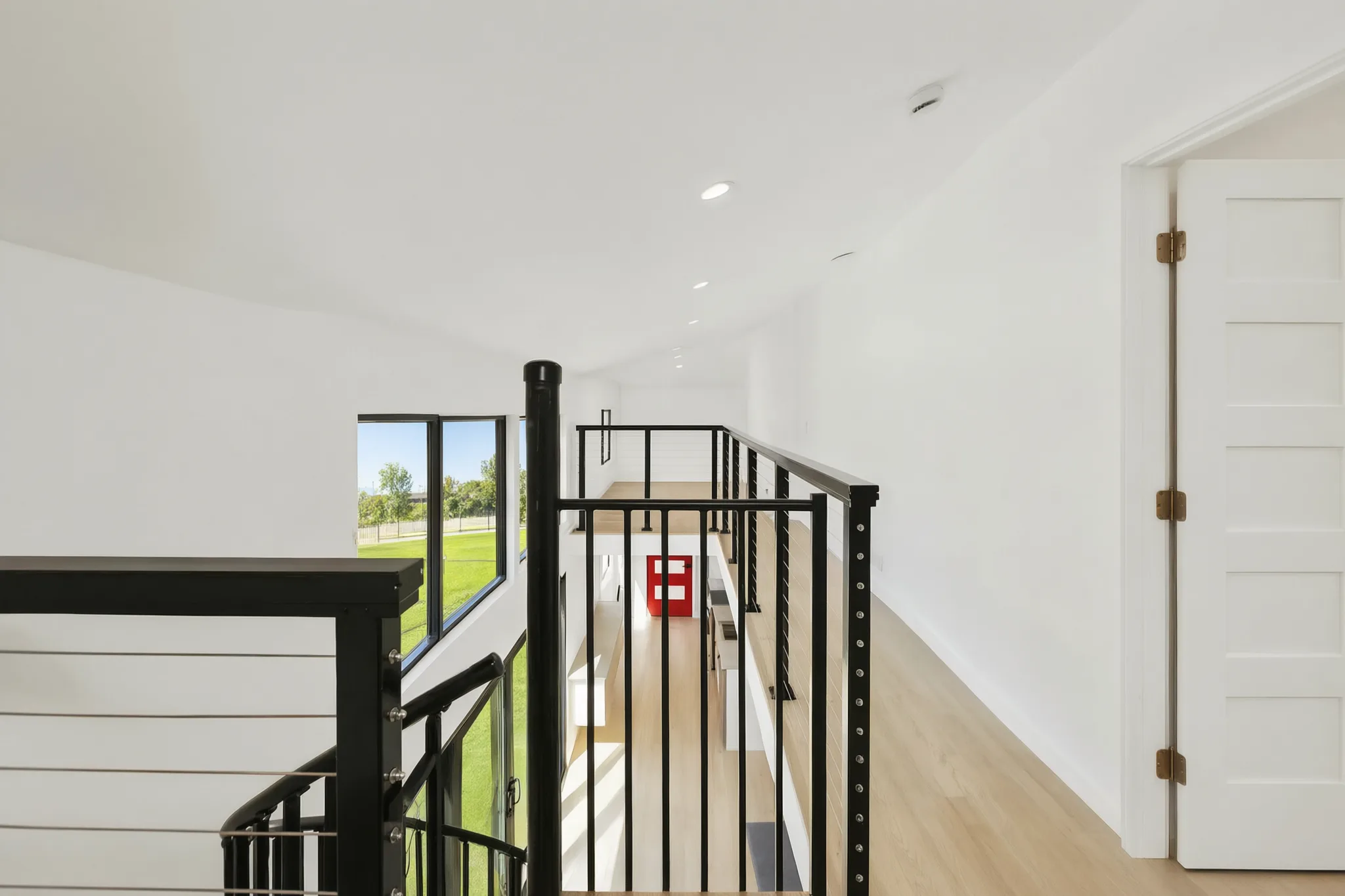 Two-story detached ADU — loft rail above the red entry door, Santa Ana Hills, Avorino