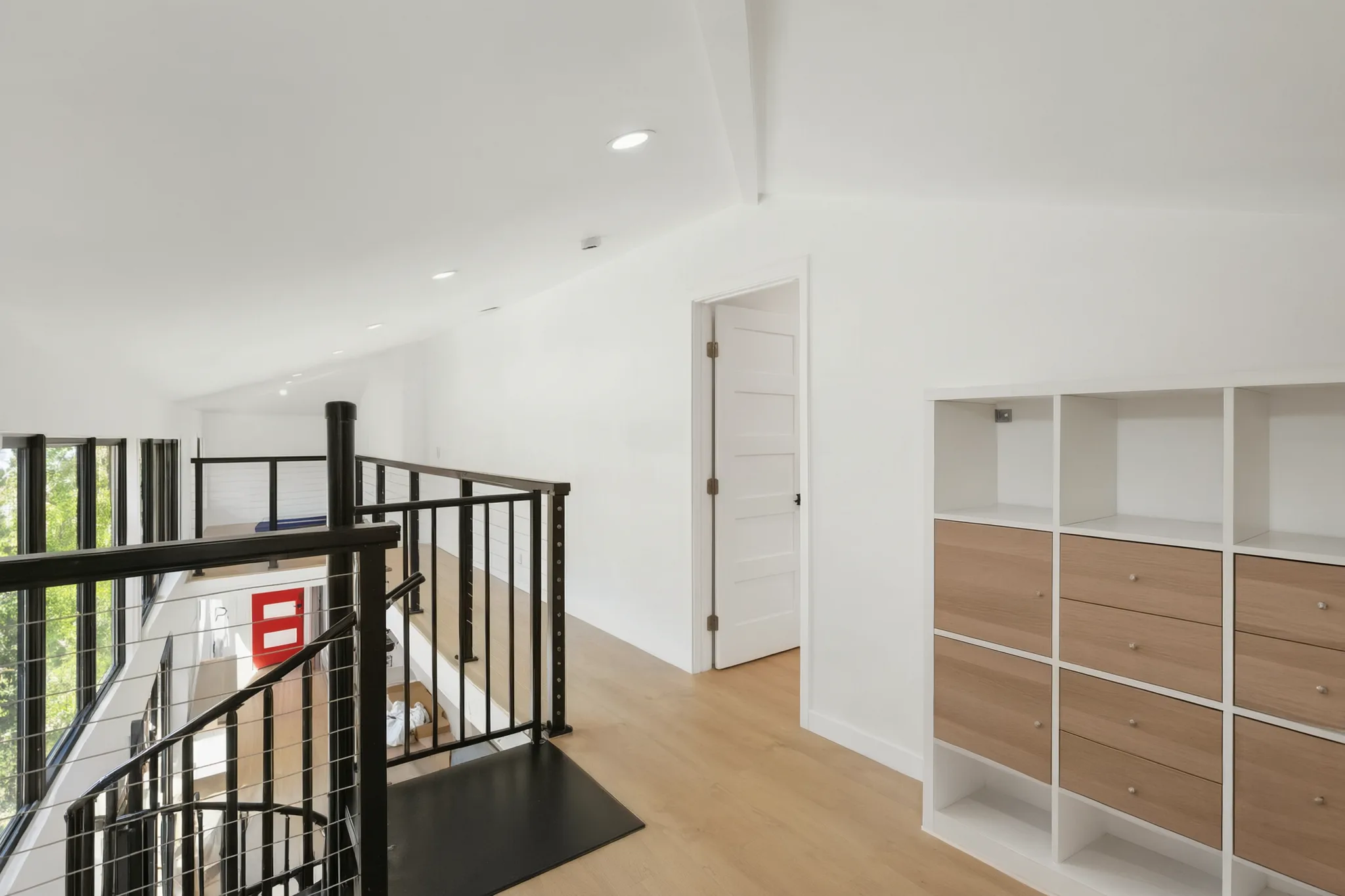 Two-story detached ADU — top of the spiral stair and built-in shelving, Santa Ana Hills, Avorino