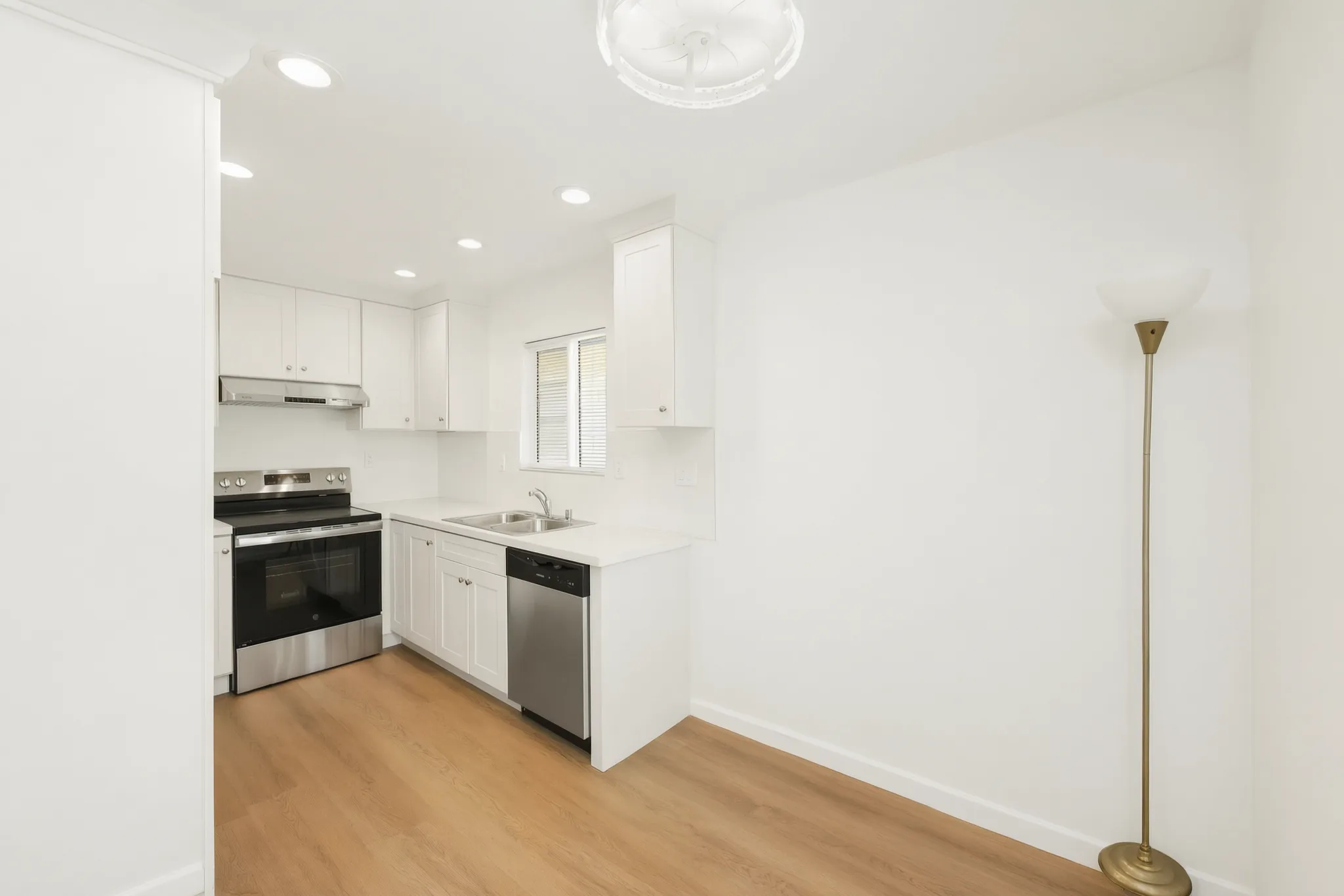 Detached ADU — kitchen run with white shaker cabinets and stainless range, Buena Park, Avorino
