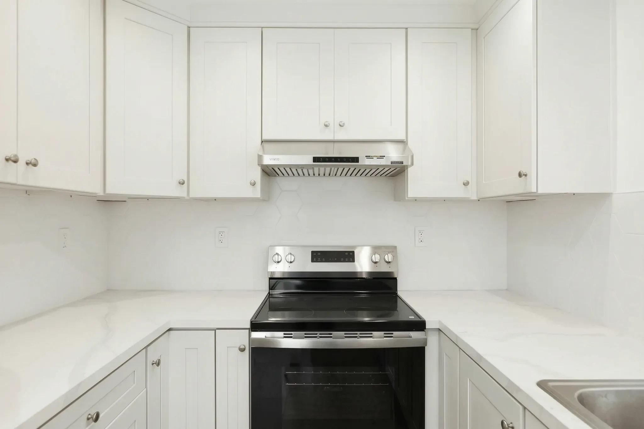 Detached ADU — range wall with white uppers and hood, Buena Park, Avorino