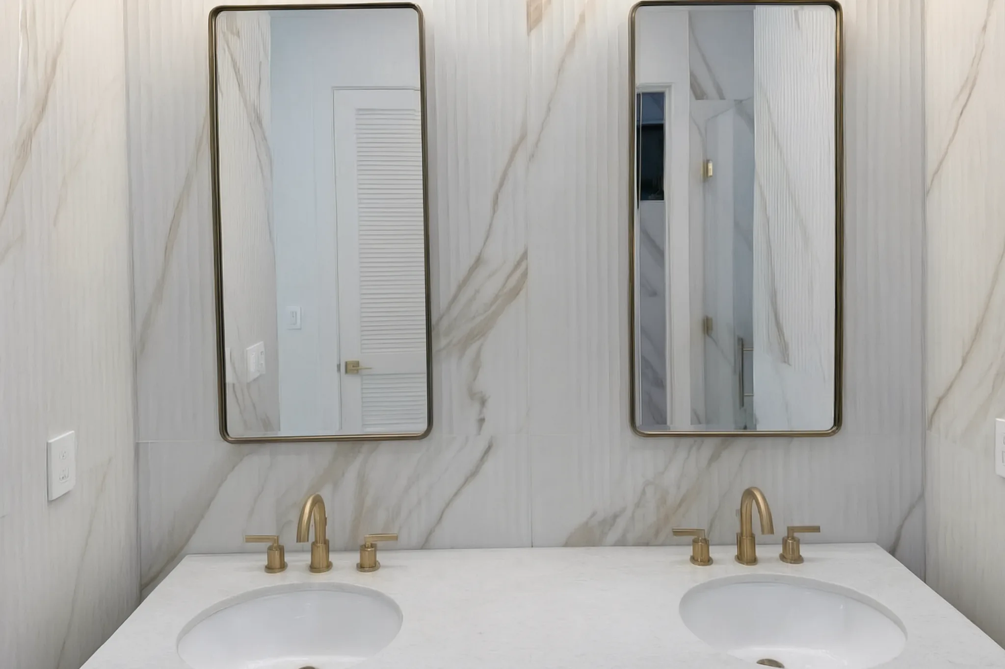 Custom pool house — double vanity mirrors on marble-look tile, San Juan Capistrano, Avorino