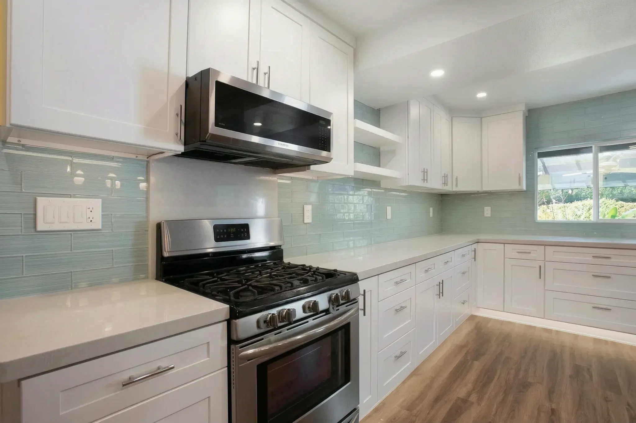 Open-concept kitchen remodel — range and microwave wall, Orange, Avorino