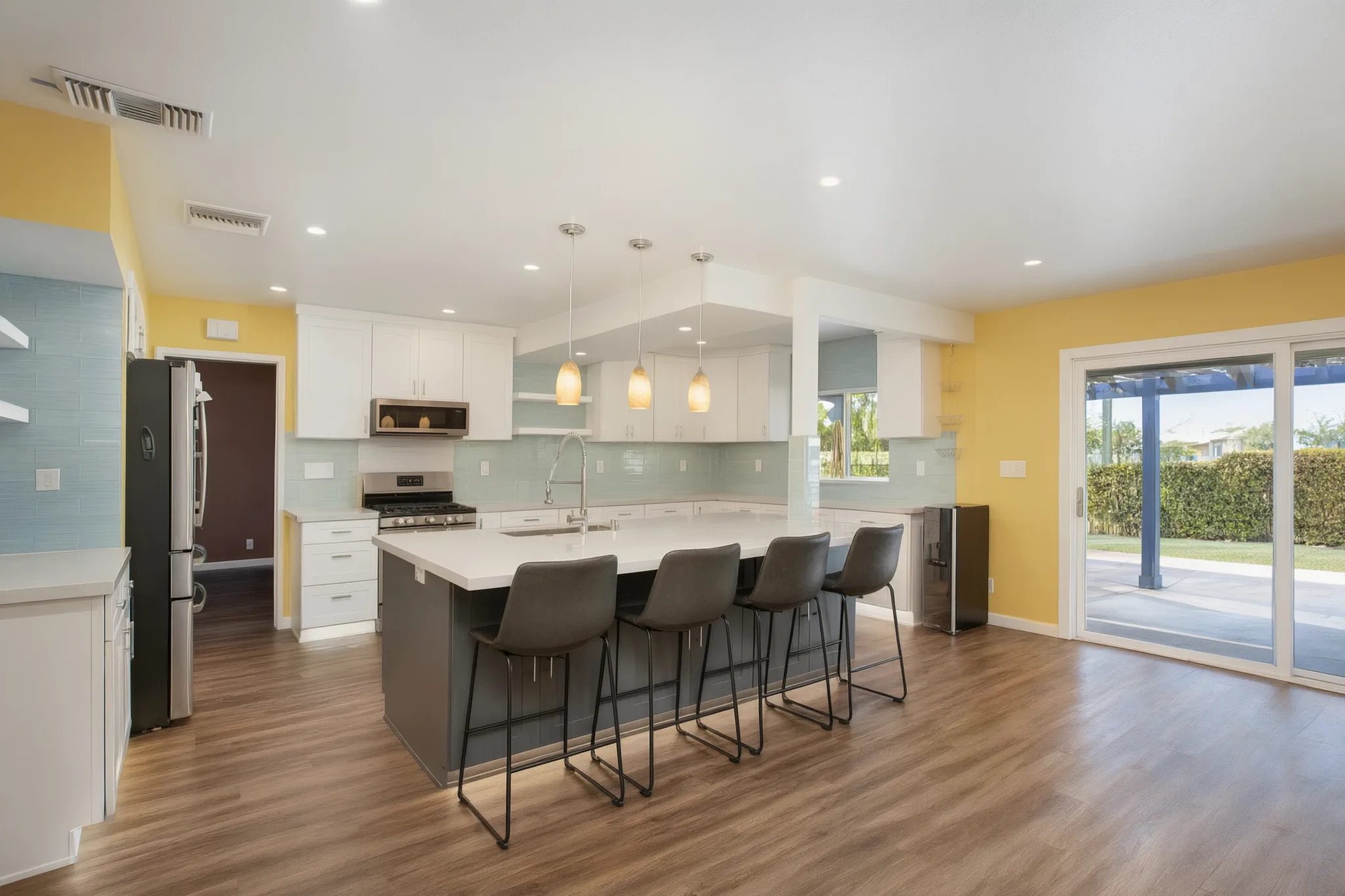 Open-concept kitchen remodel — island with seating and sliders to the yard, Orange, Avorino