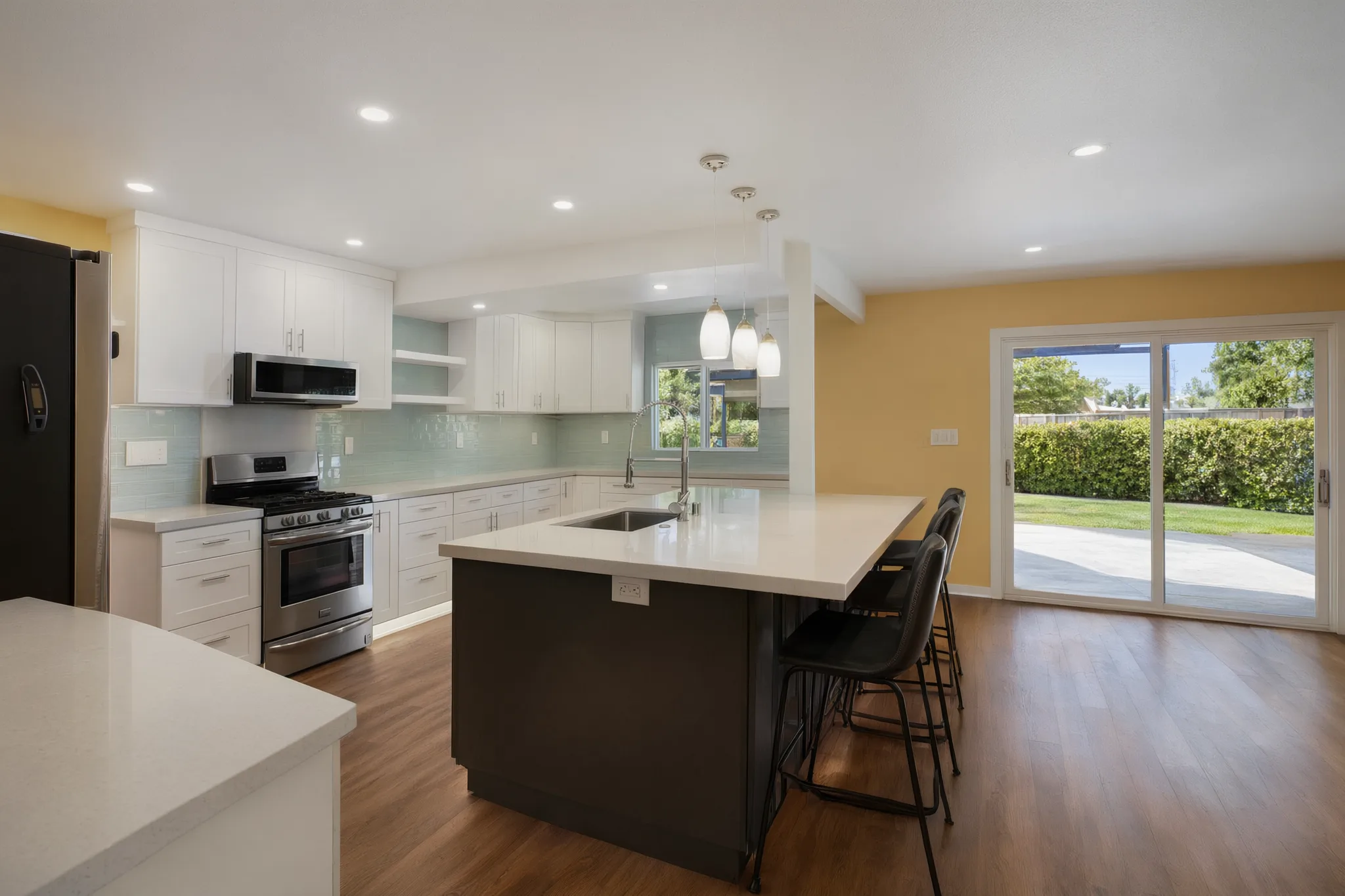 Open-concept kitchen remodel — range wall and island seating, Orange, Avorino