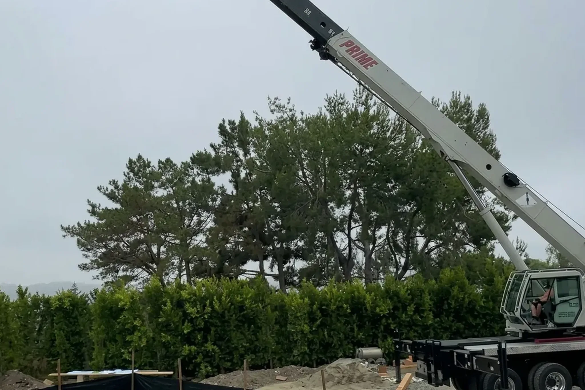 Pool house under construction — crane on site as the walls go up beside the pool, San Juan Capistrano, Avorino