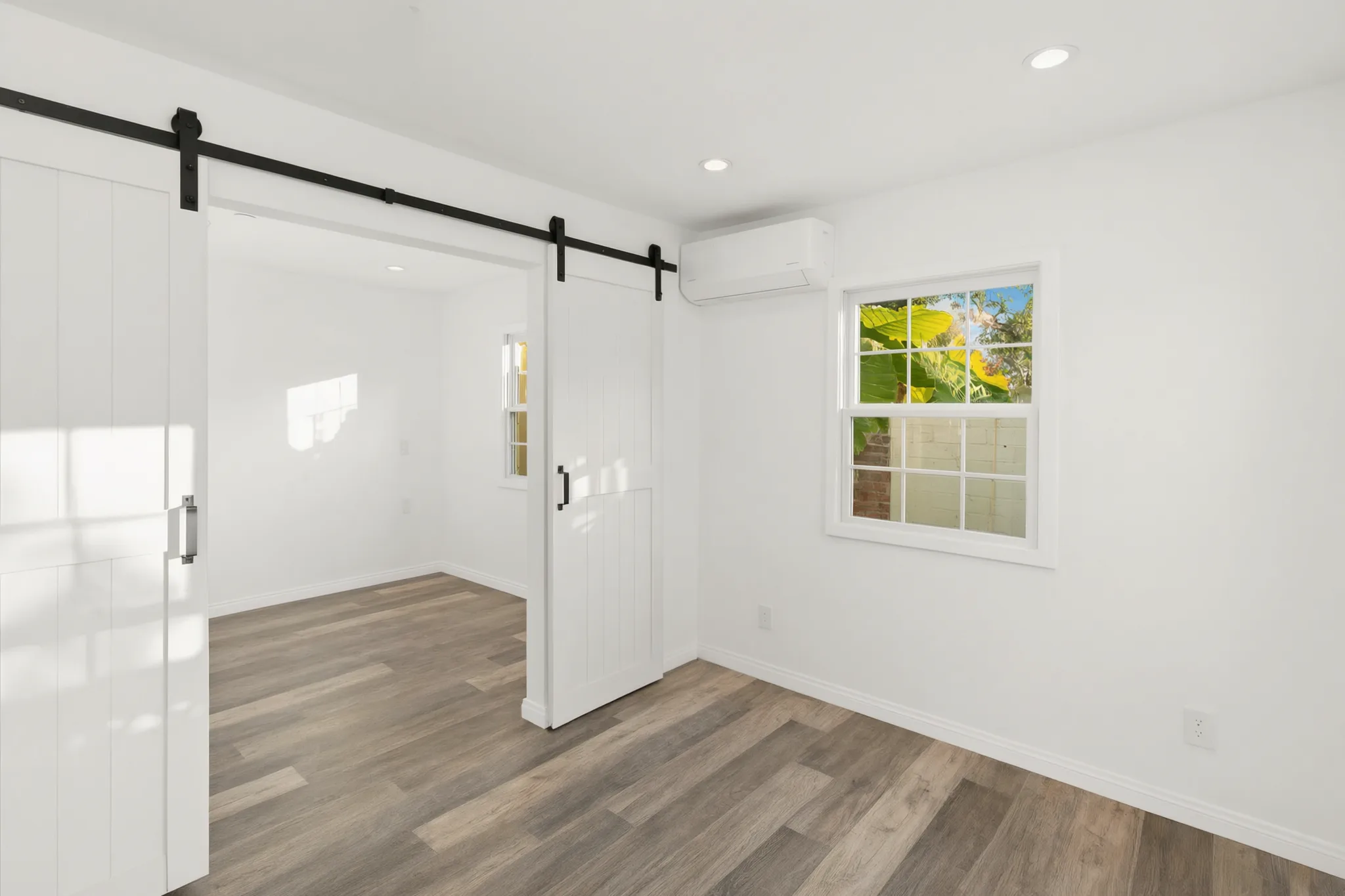 Attached ADU — bedroom with barn door, Orange, Avorino