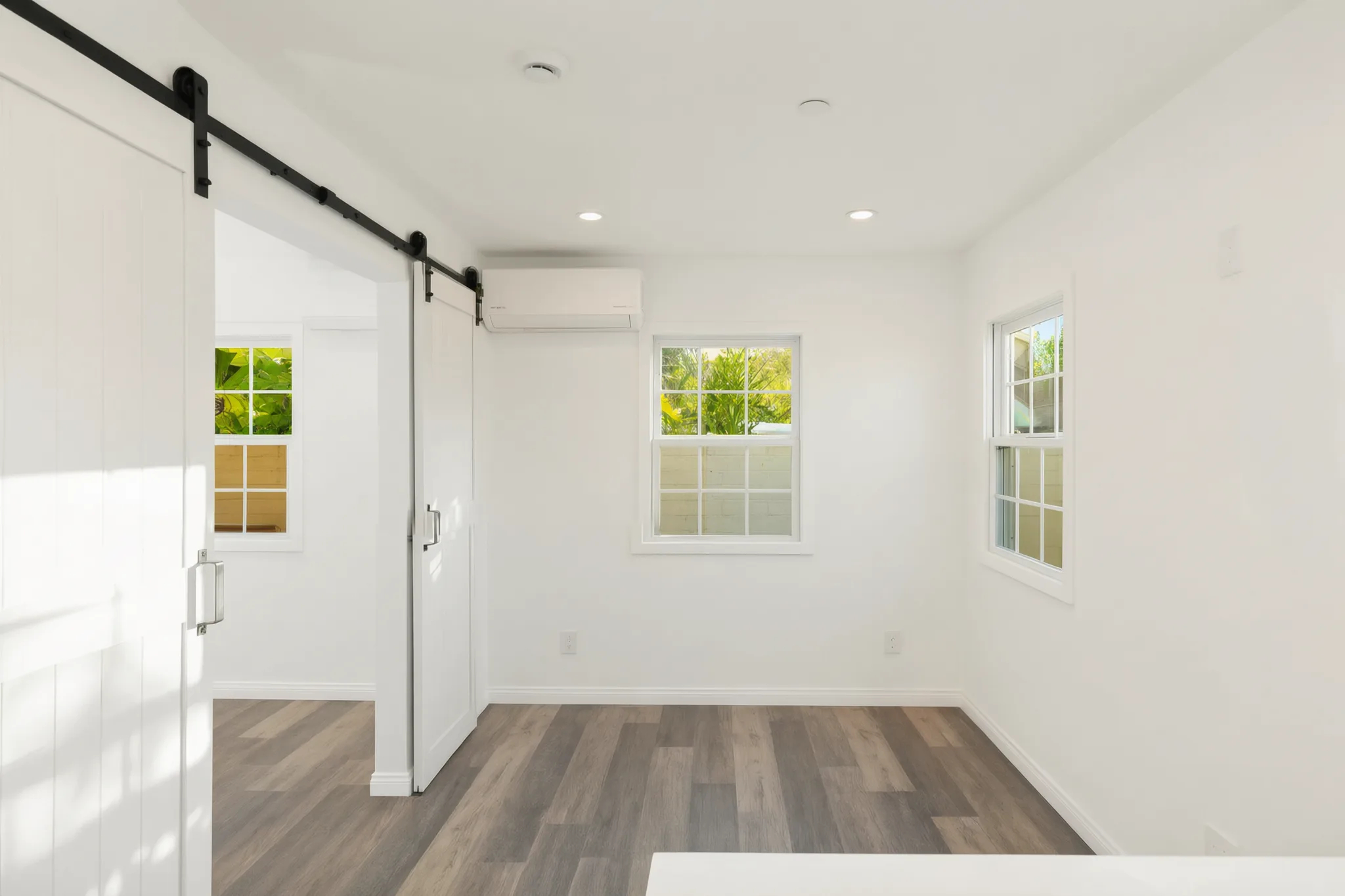 Attached ADU — bedroom behind the barn door, Orange, Avorino