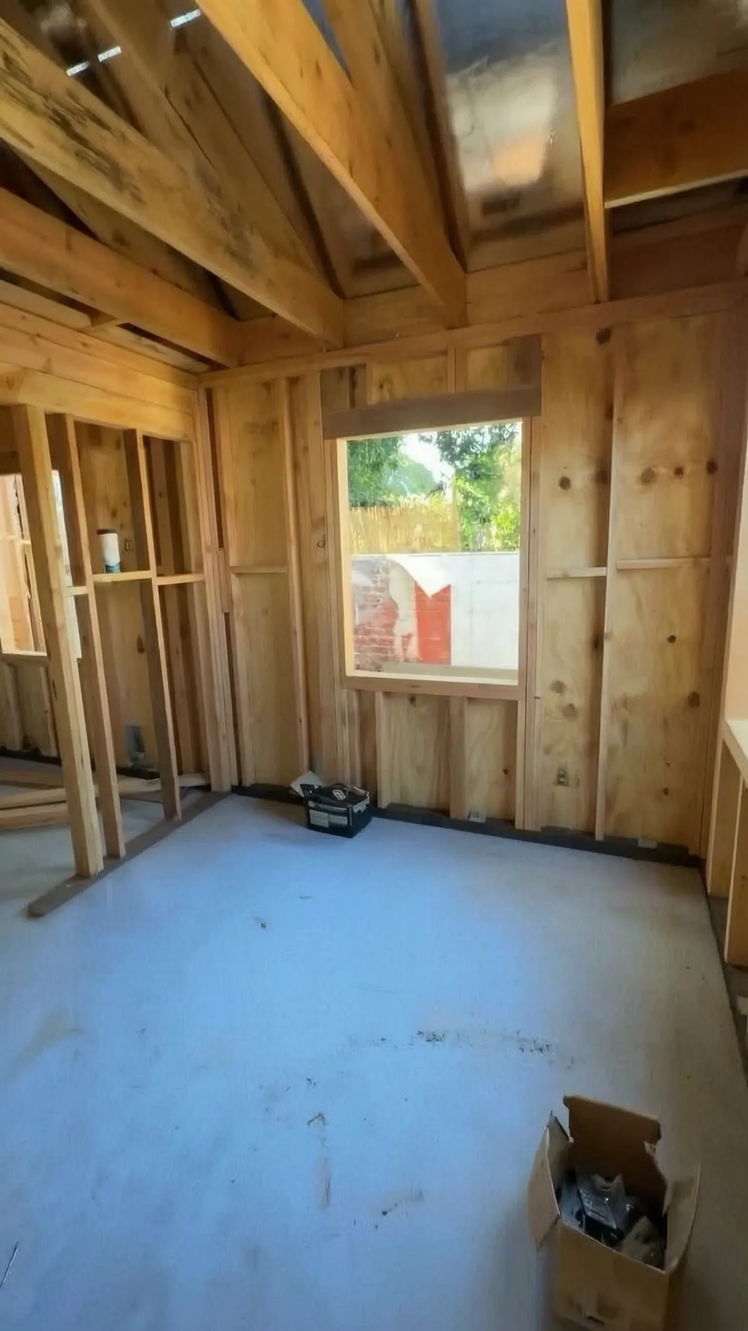 Attached ADU under construction — sheathed wall with the framed window opening, Orange, Avorino