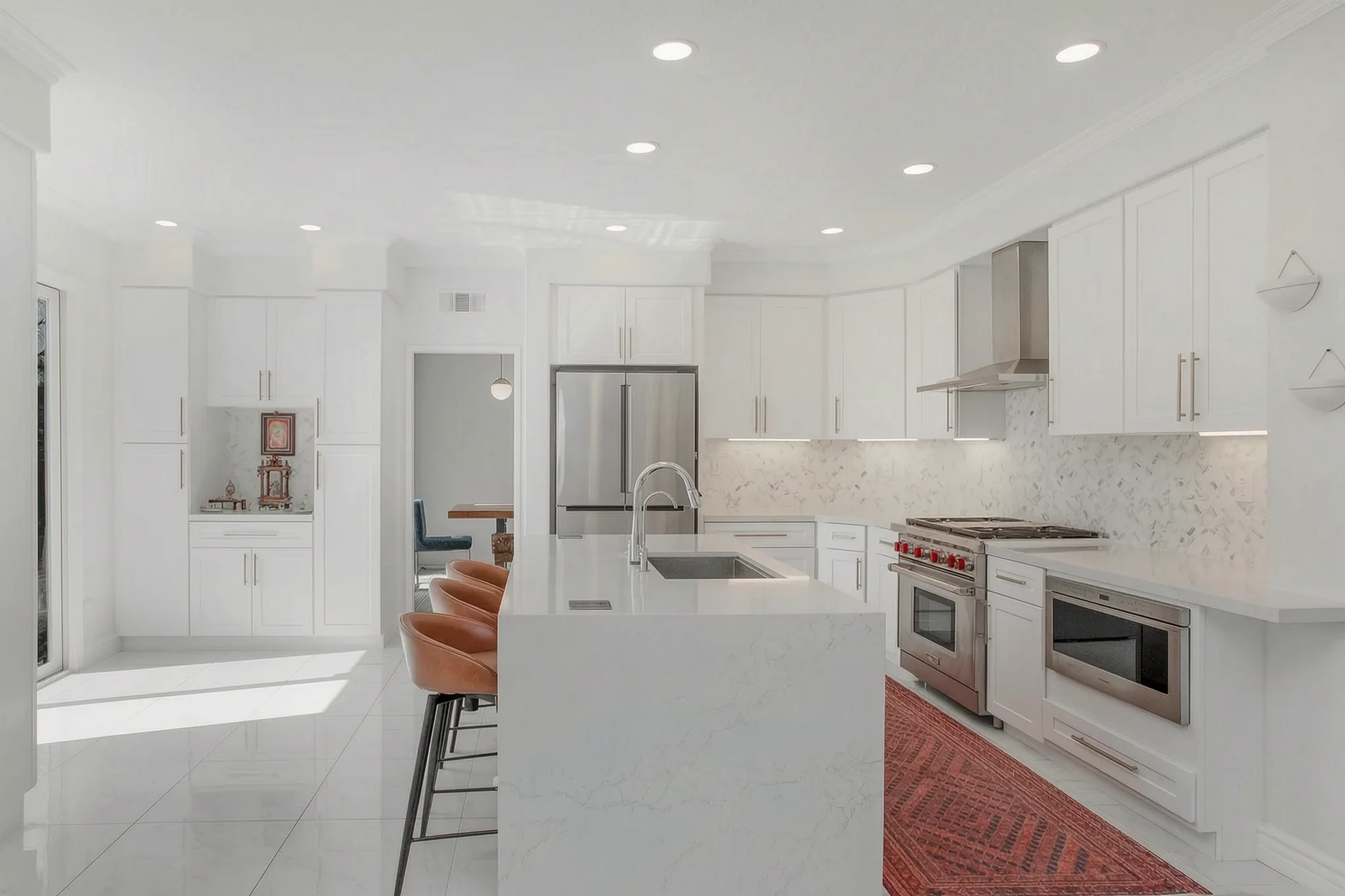 Custom home — white kitchen with island seating and marble backsplash, Aliso Viejo, Avorino
