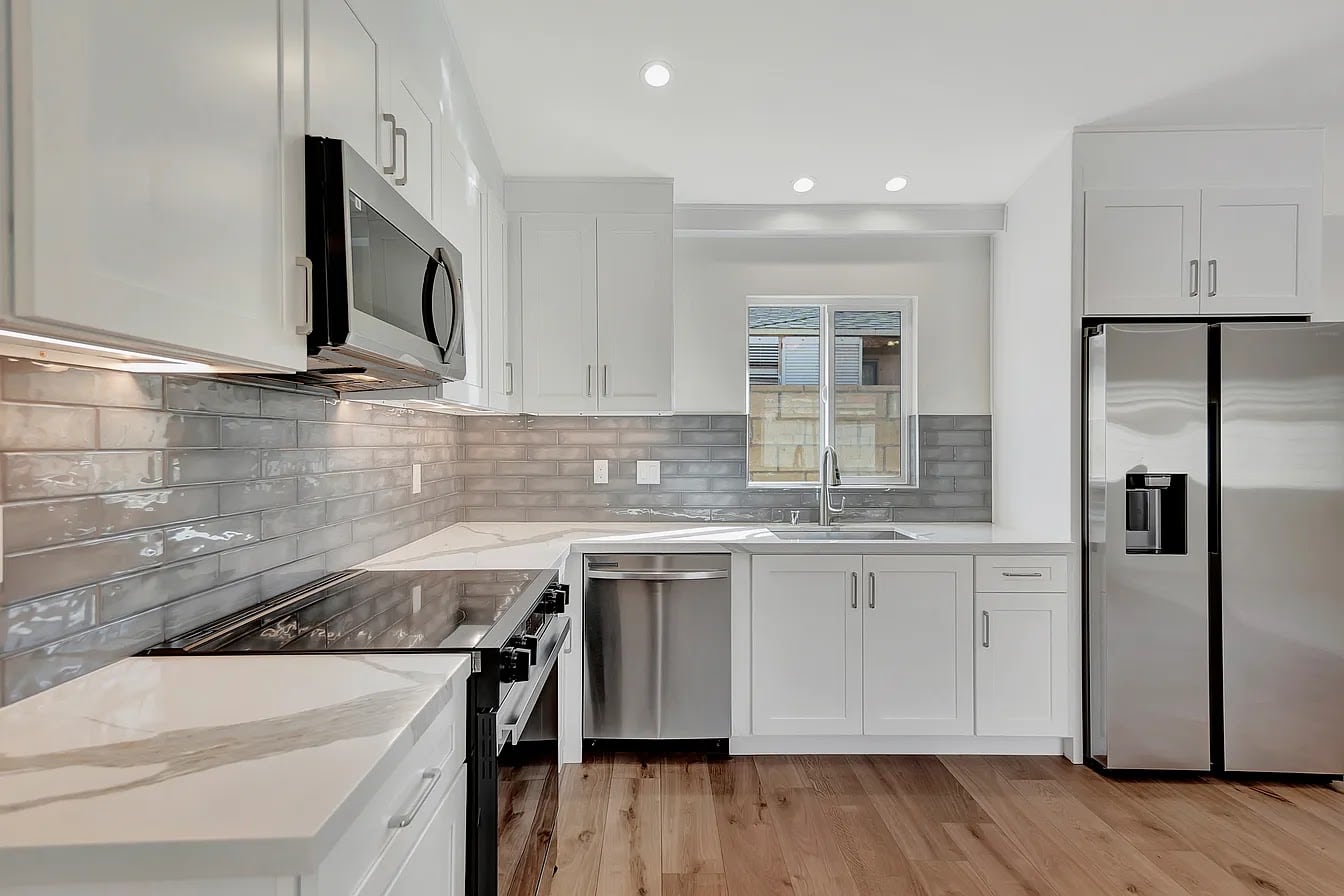 Detached ADU white-shaker kitchen with quartz counters — Avorino