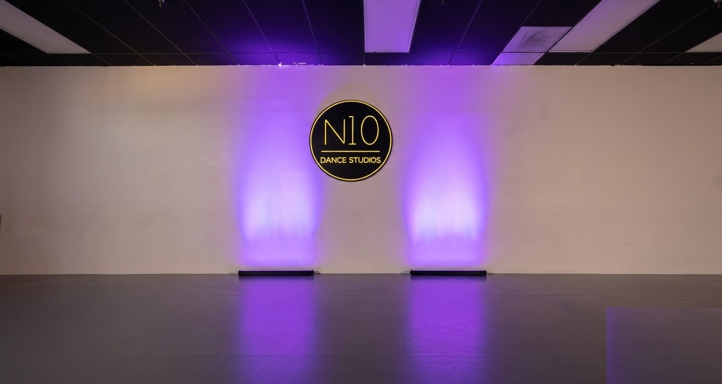N10 Dance Studio branded feature wall with lighting, Orange County