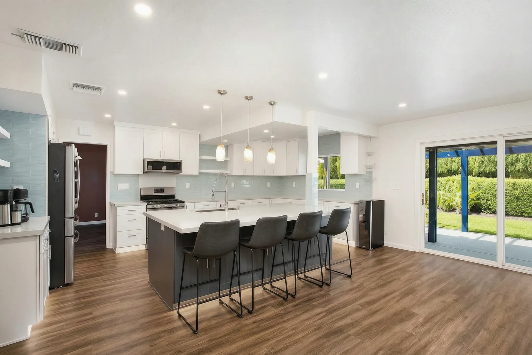 The finished open-concept kitchen of the same remodel in Orange, built by Avorino.