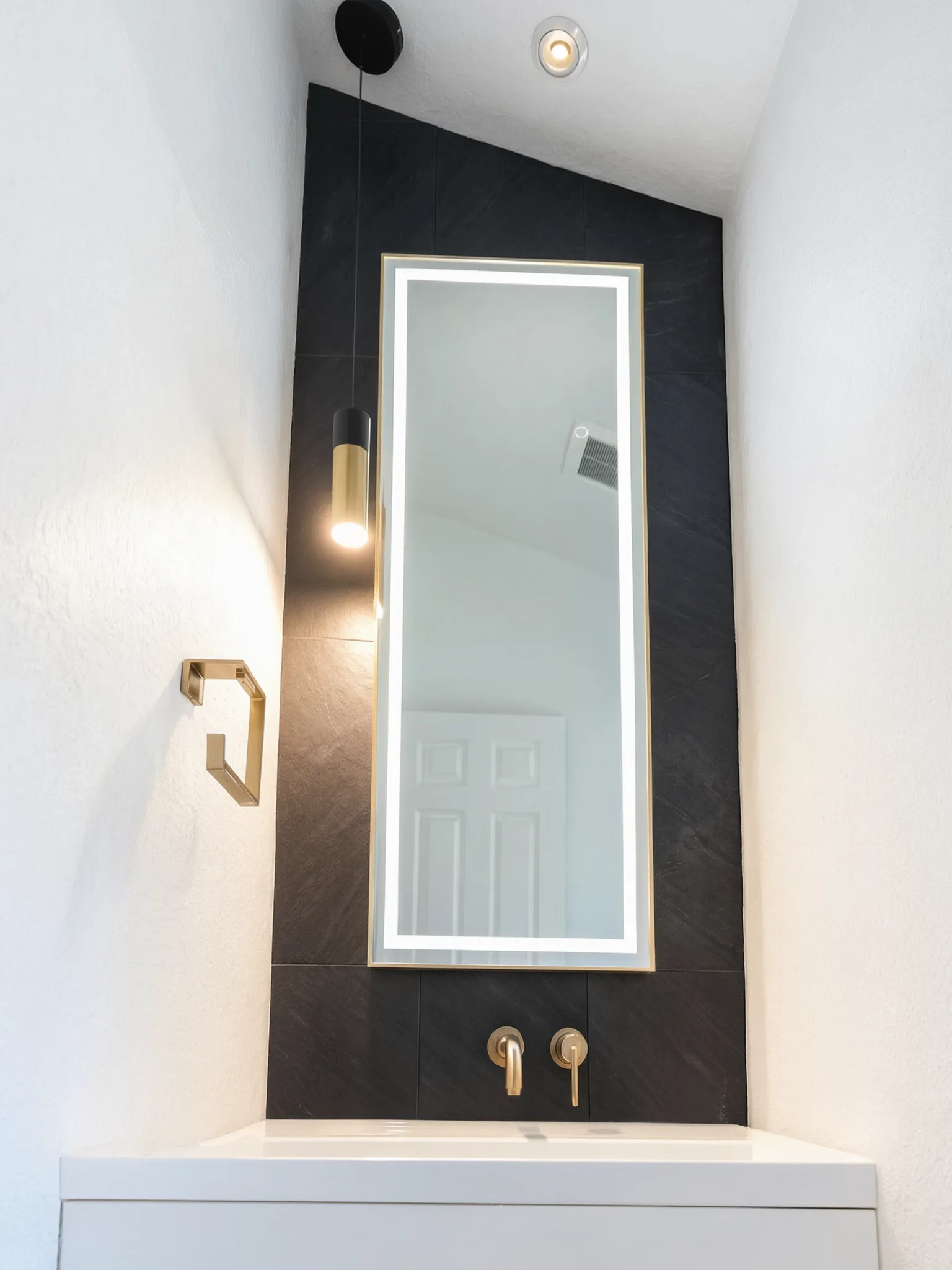 Whole-home remodel — bath with tall lit mirror on slate tile, Orange, Avorino