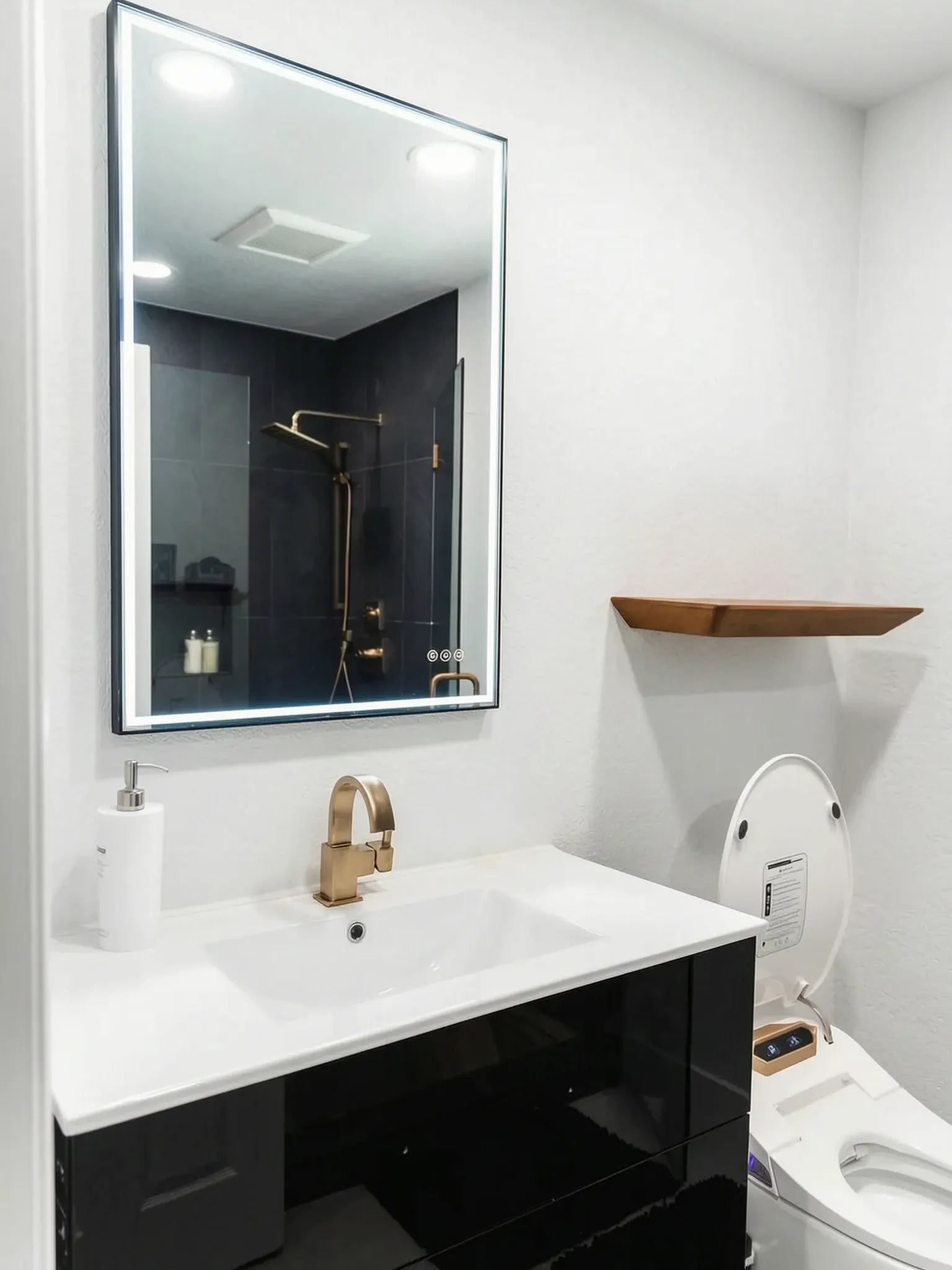 Whole-home remodel — bath vanity with lit mirror and floating shelf, Orange, Avorino