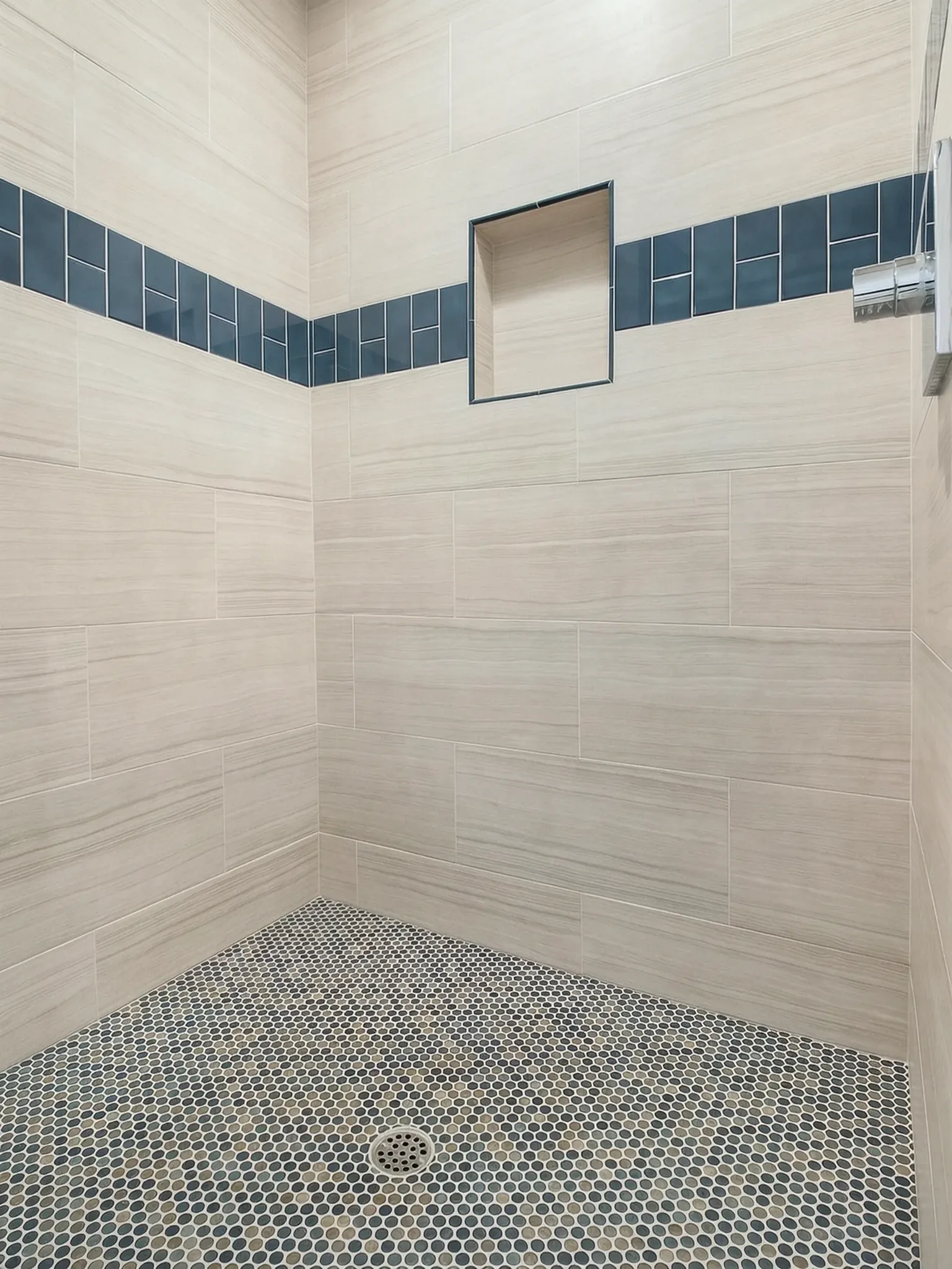 Primary bath remodel — marble shower with navy tile band, Avorino
