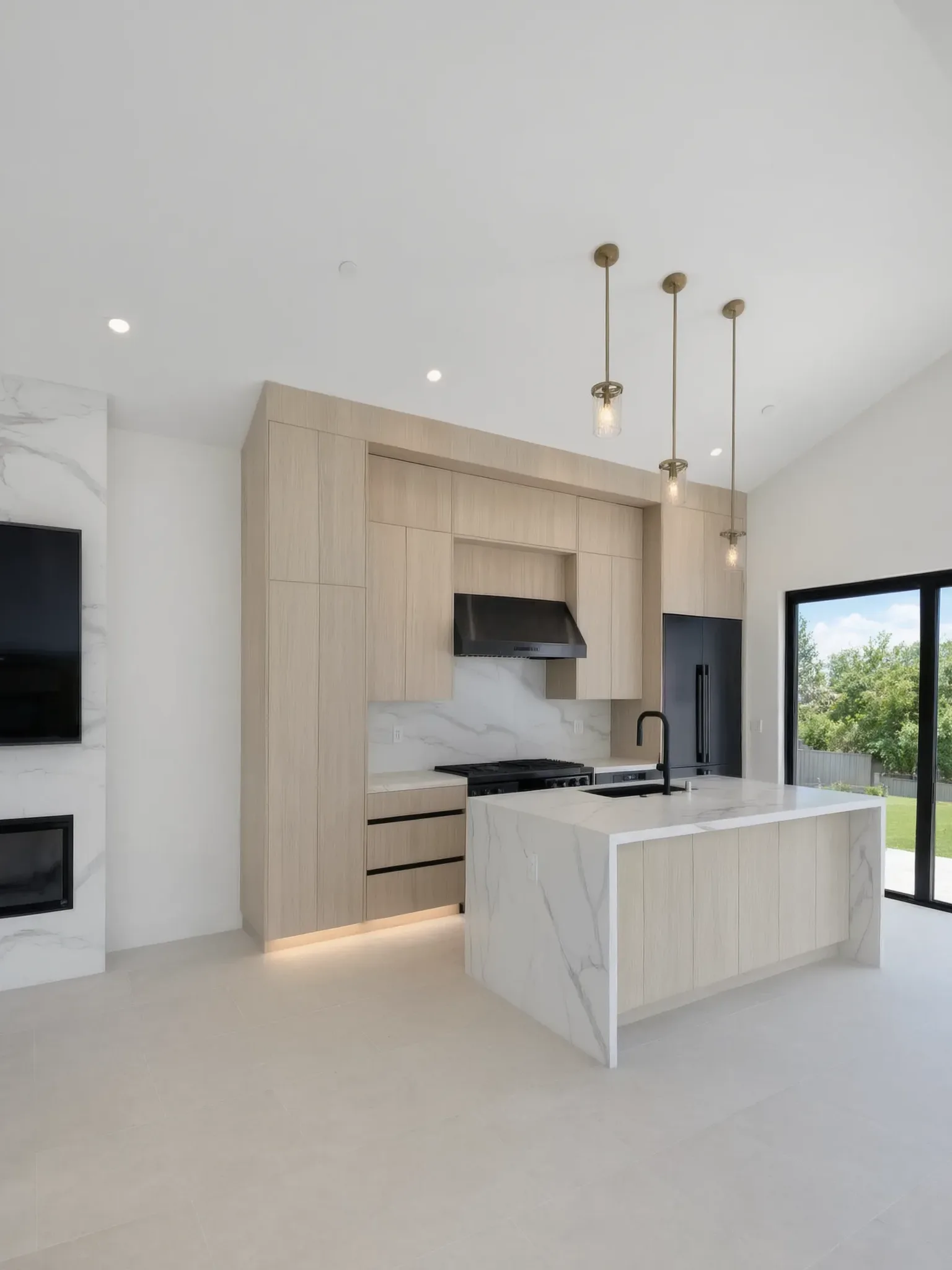 The finished kitchen of an Avorino pool house in San Juan Capistrano: light wood cabinetry and a marble waterfall island under a vaulted ceiling