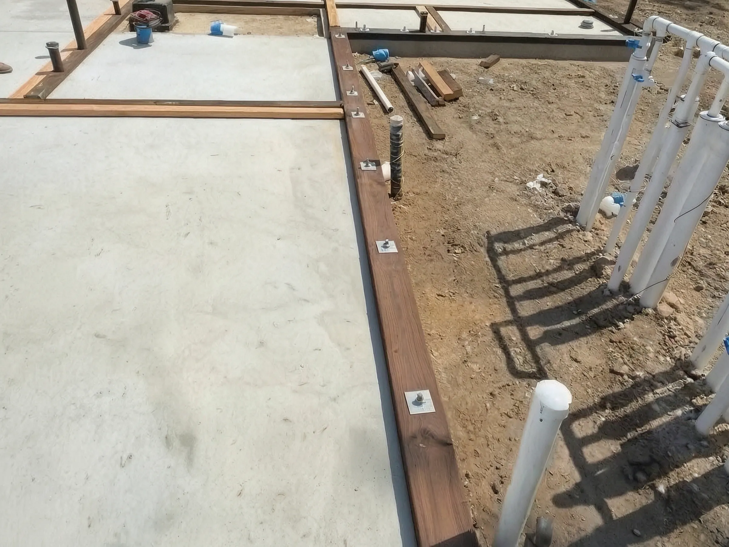 Concrete poured, with sill plates and utility stubs in place. Pool house, San Juan Capistrano, built by Avorino.