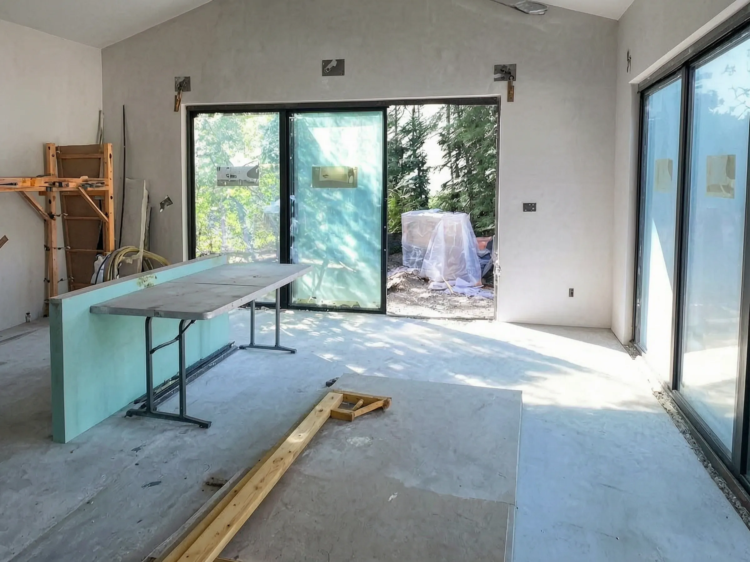 Drywall up and the sliding glass doors installed. Pool house, San Juan Capistrano, built by Avorino.