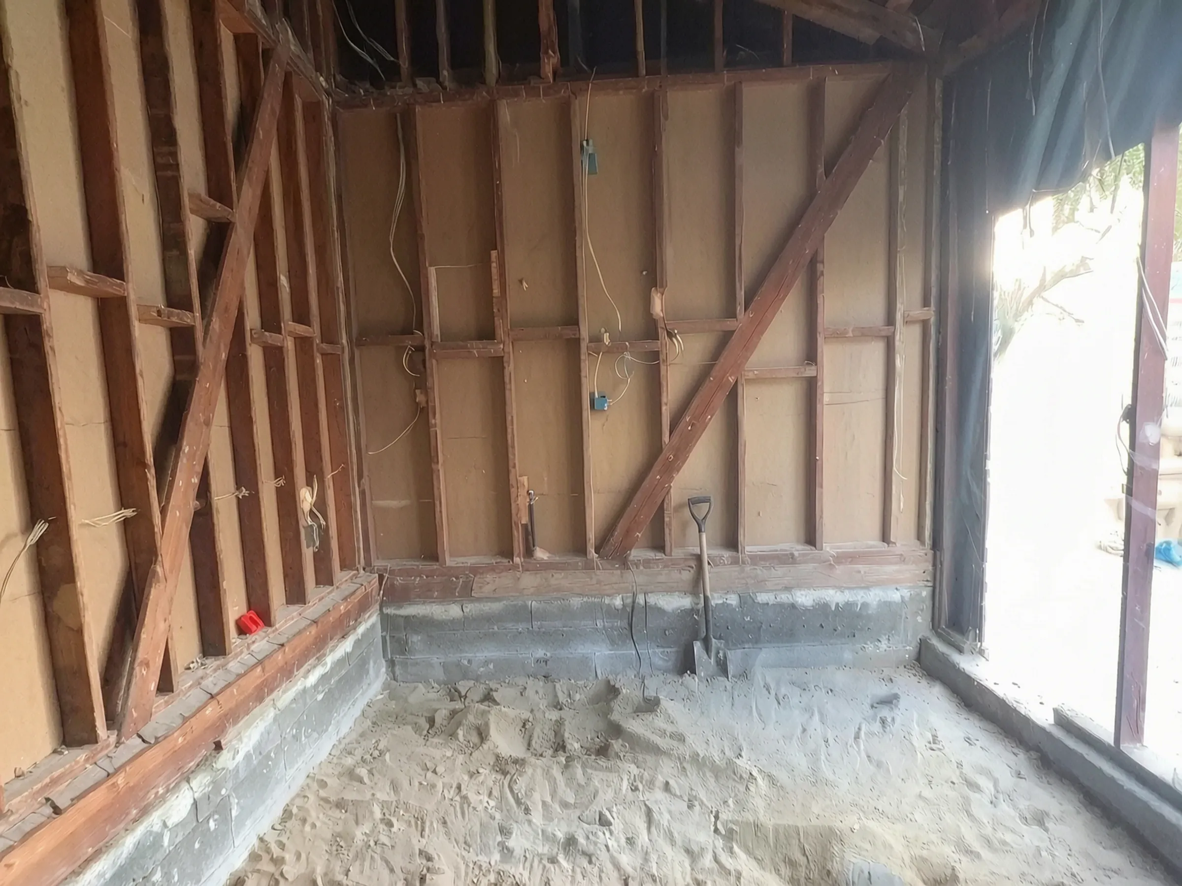 The garage gutted to its studs. Garage-to-ADU conversion, La Habra, built by Avorino.