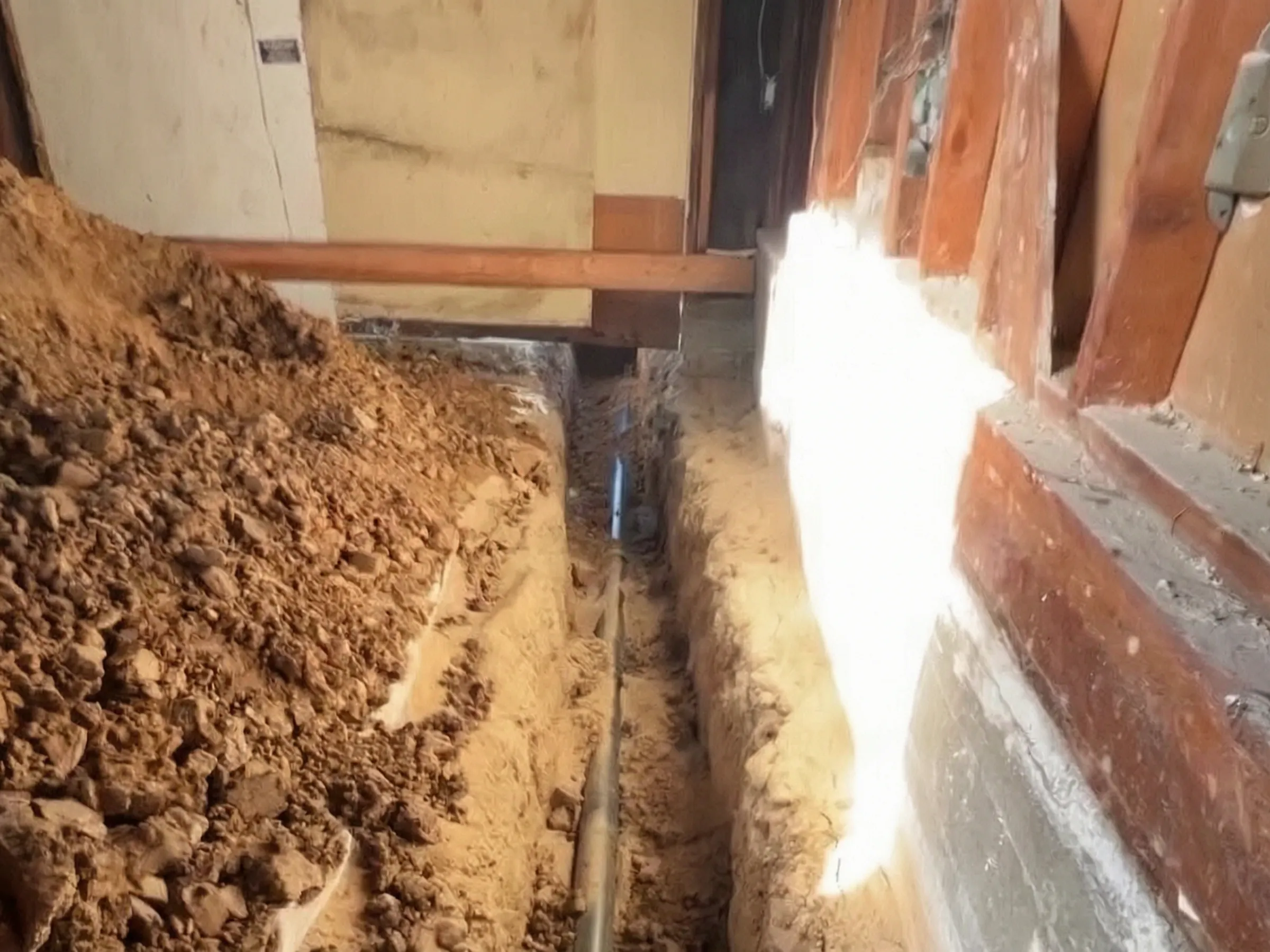 A trench dug for the underground work. Garage-to-ADU conversion, La Habra, built by Avorino.