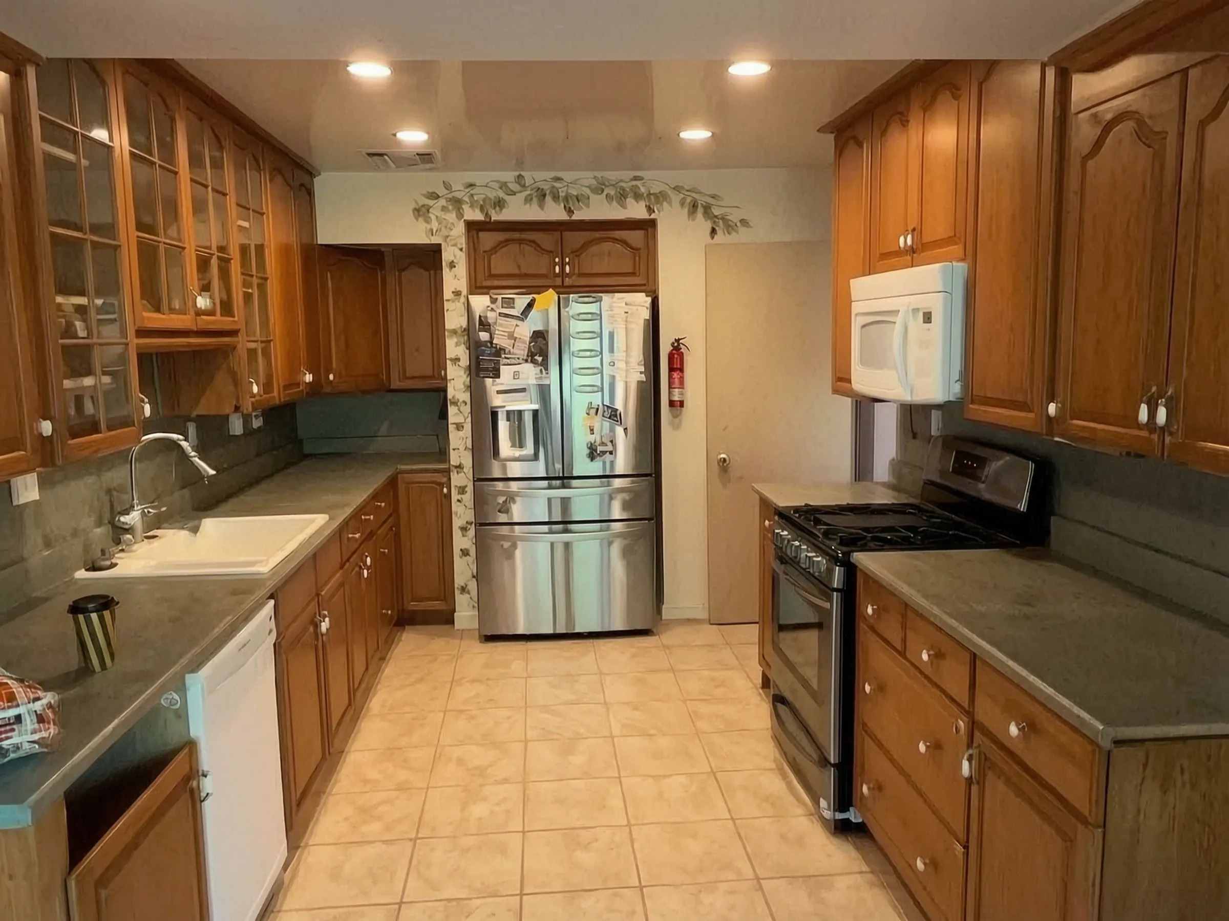 The kitchen before, with honey-oak cabinets. Kitchen remodel, Orange, by Avorino.
